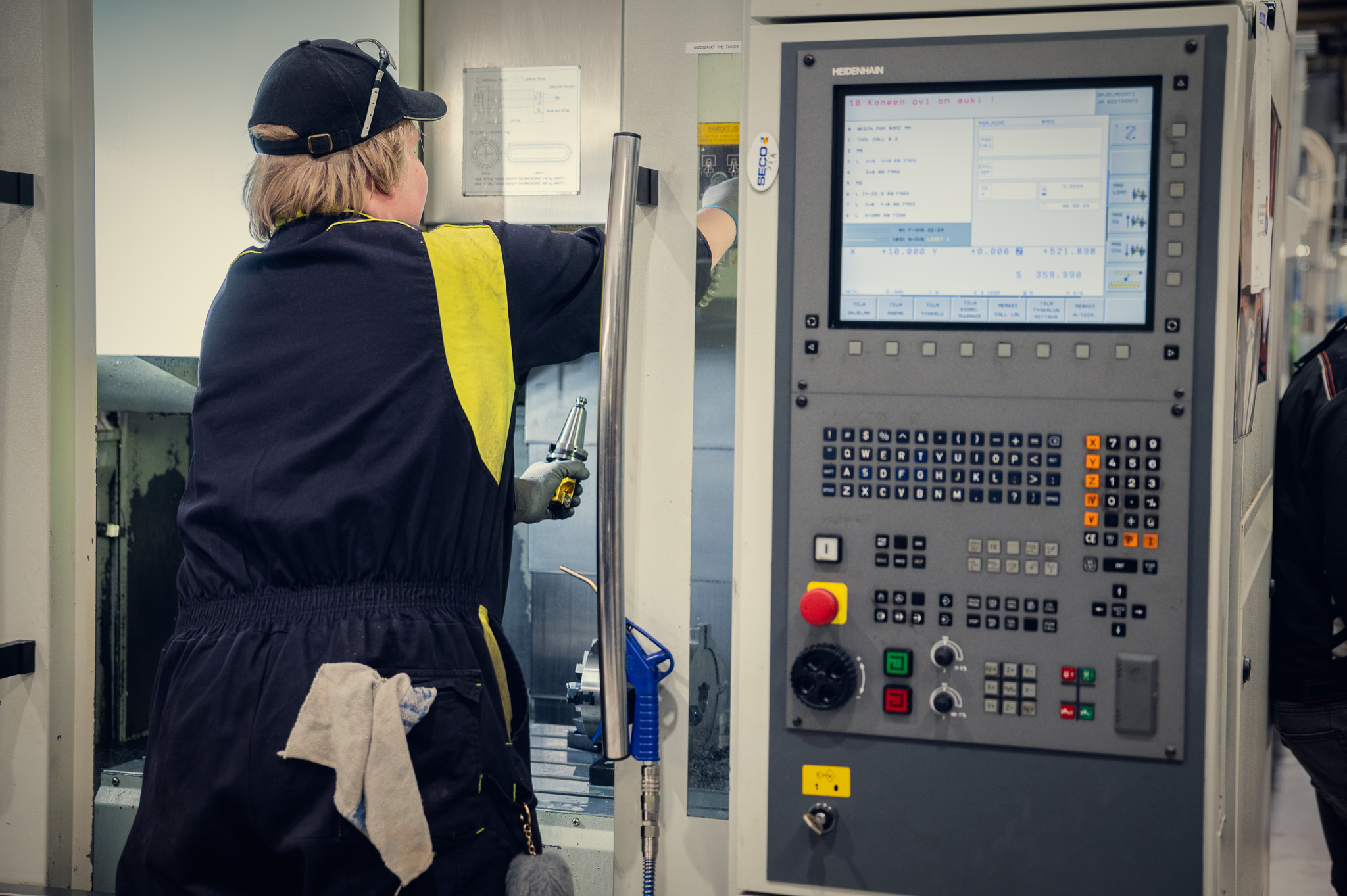 Machine operator working at a CNC control panel